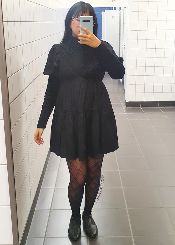 A bathroom mirror selfie showing issue 7's pub night outfit